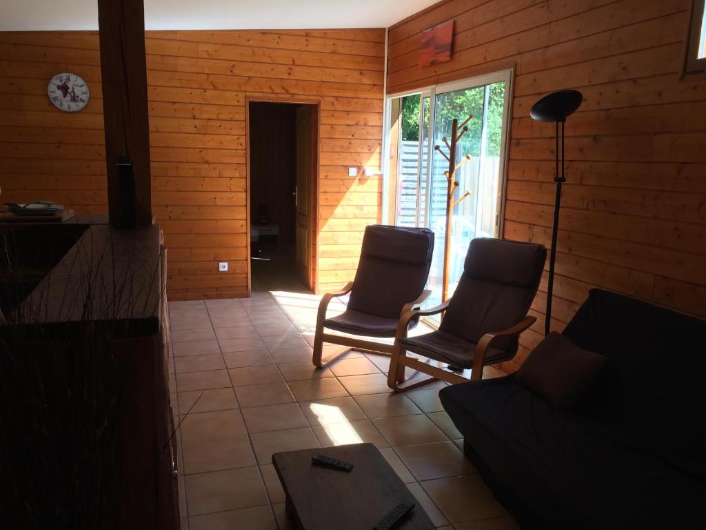 a living room with two chairs and a couch at chez steph&aurore in Lacanau