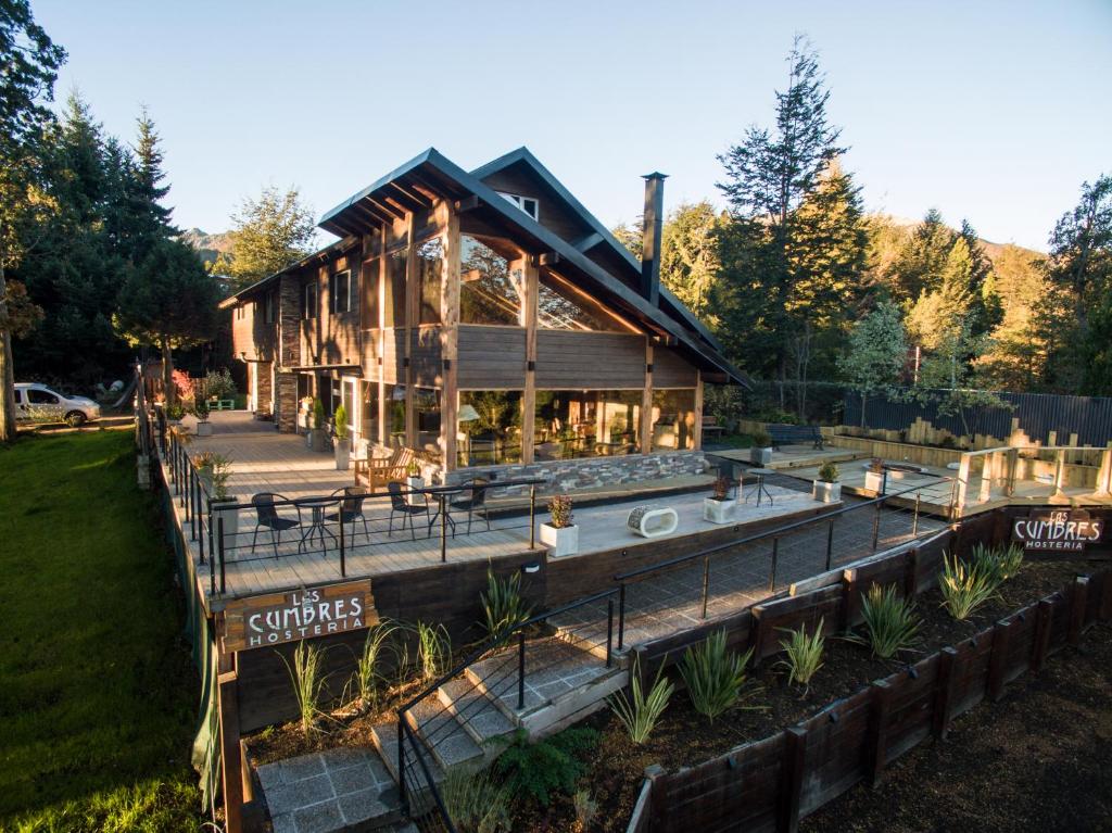 a large wooden building with a restaurant at Hostería Las Cumbres in Villa La Angostura