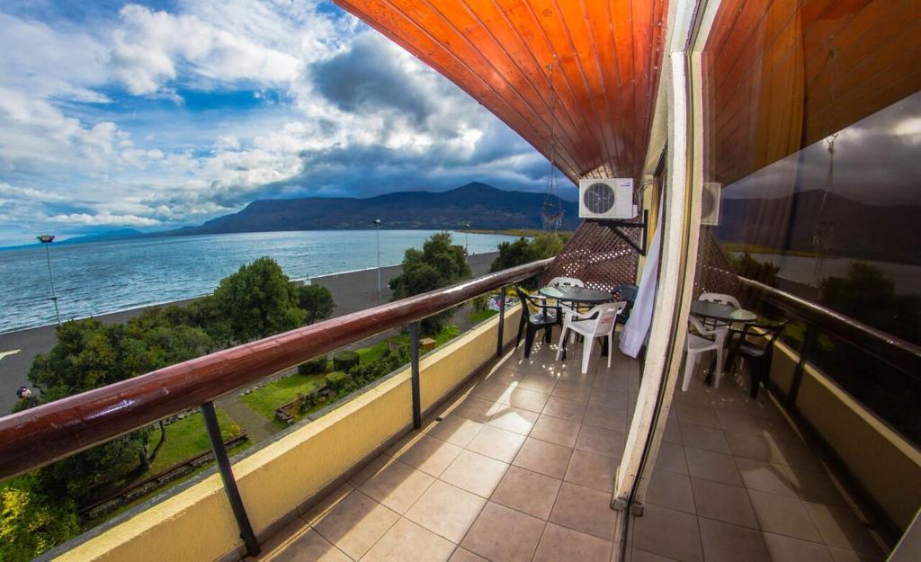 a balcony with a view of the water at Departamentos La Casona in Pucón