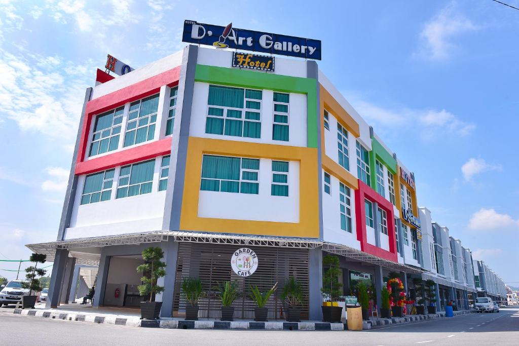 a brightly colored building with a sign on it at D' ART GALLERY HOTEL in Seri Iskandar