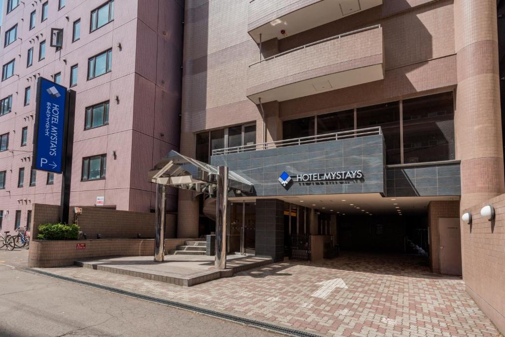 a building with a sign in front of it at HOTEL MYSTAYS Sapporo Nakajima Park Annex in Sapporo