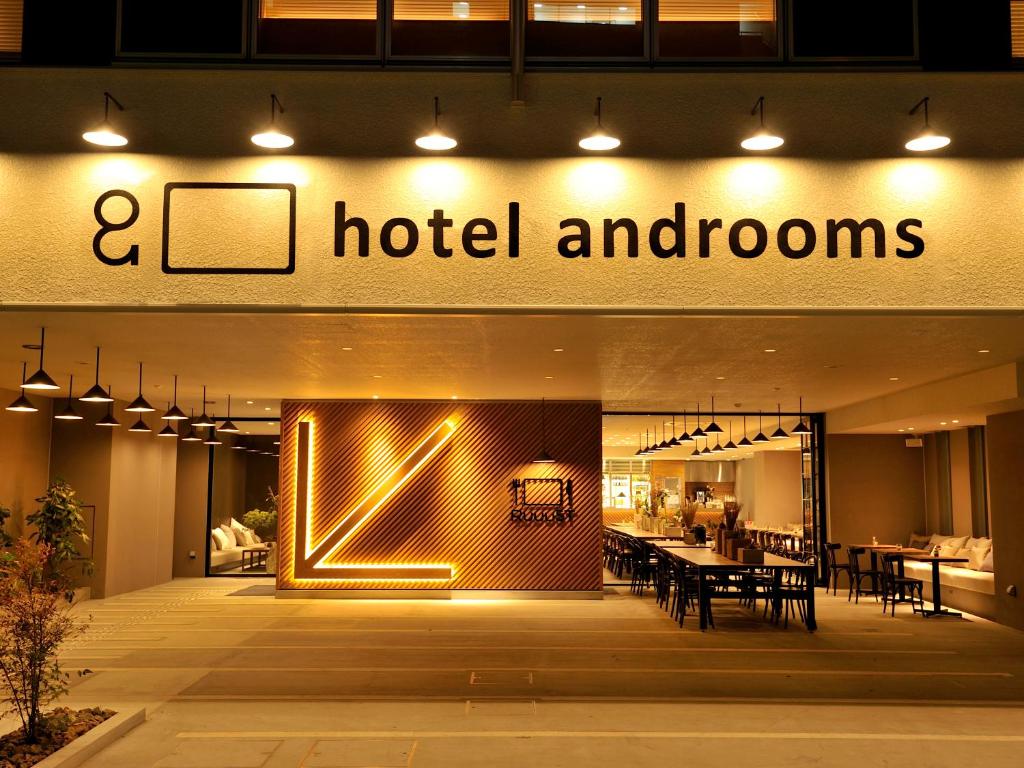 a large building with a clock on the front of it at hotel androoms Osaka Hommachi in Osaka