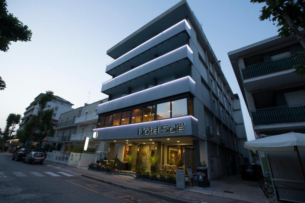 a building with a hotel store on a city street at Hotel Sole in Cattolica