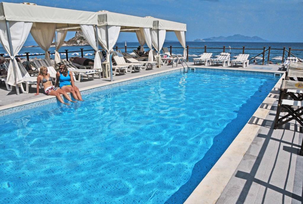 two women sitting in a swimming pool on a cruise ship at Sacallis Inn Beach Hotel in Kefalos