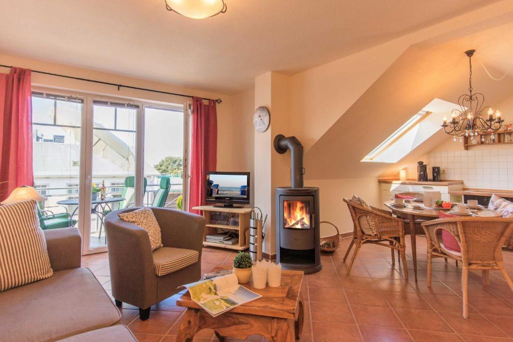 a living room with a couch and a fireplace at Ferienwohnung Ihr Zuhause am Meer in Thiessow