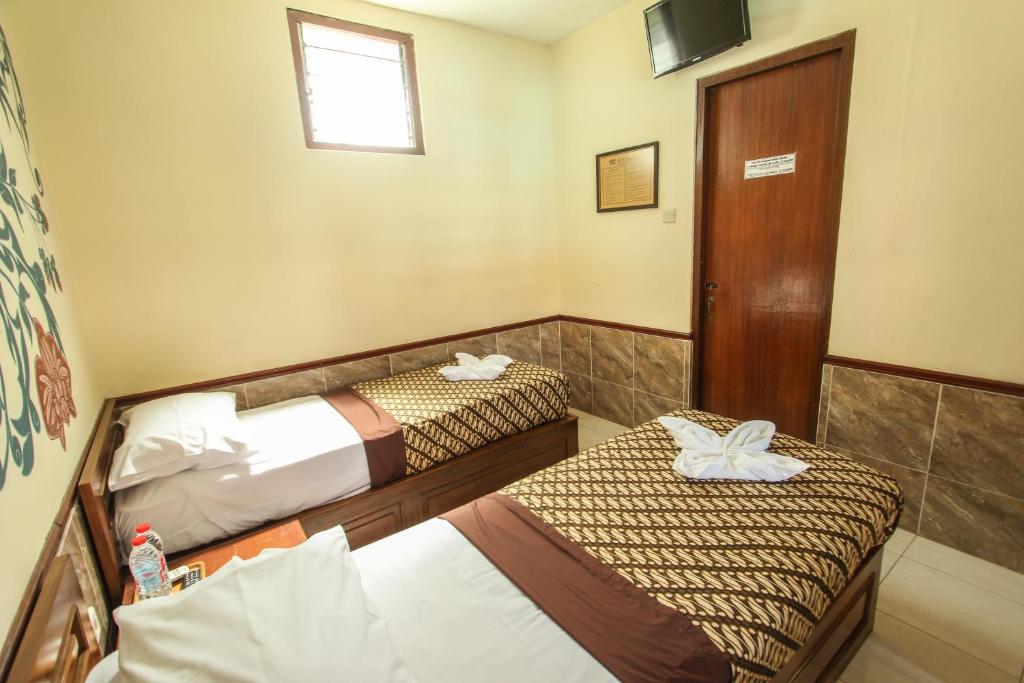 Postel nebo postele na pokoji v ubytování Delta Homestay
