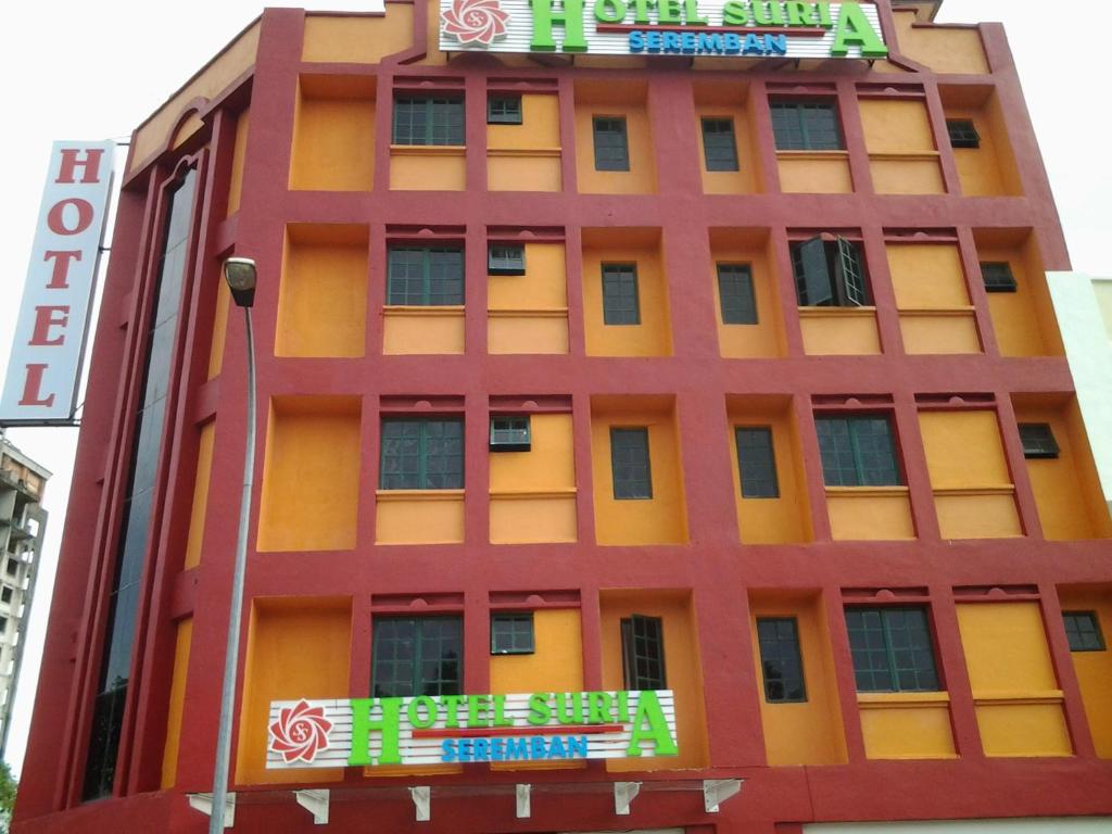 an orange building with colorful signs on it at Suria Seremban Hotel in Seremban