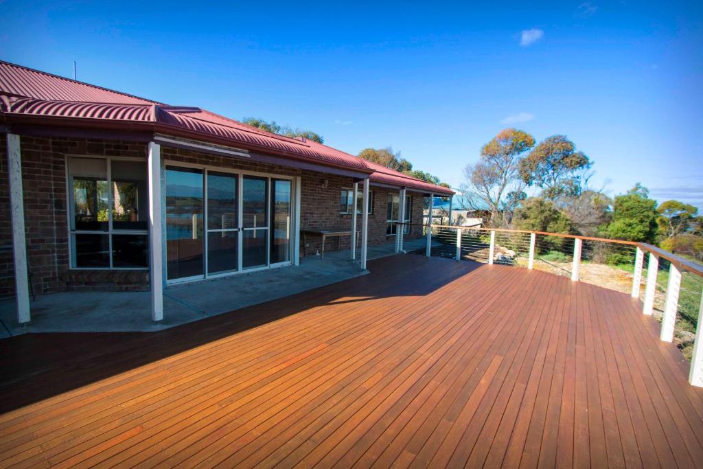 a large wooden deck in front of a building at Limestone Ridge in Tailem Bend