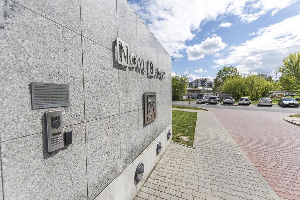 a building with a sign on the side of it at P&O Apartments Metro Mlociny in Warsaw