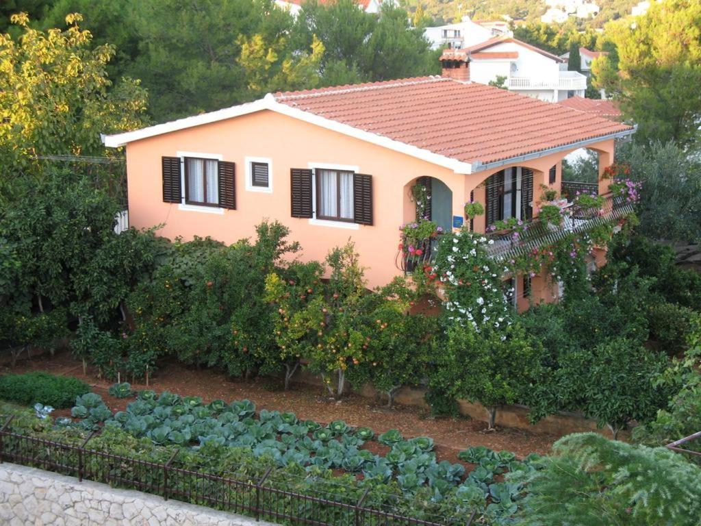 a house with a vegetable garden in front of it at Apartments Ivanka in Trogir