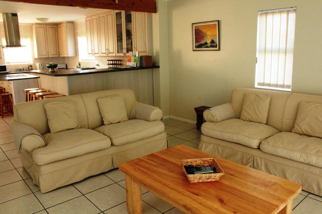 a living room with two couches and a coffee table at Kian's Place Holiday Home in Langebaan