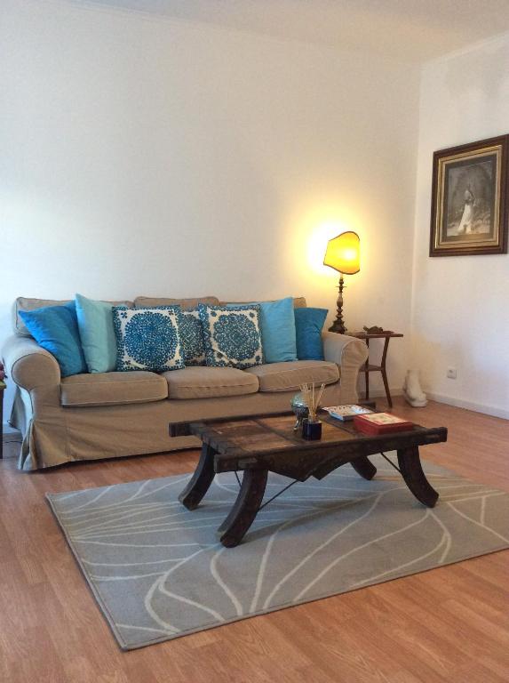 a living room with a couch and a coffee table at Marina Lounge Home in Ponta Delgada