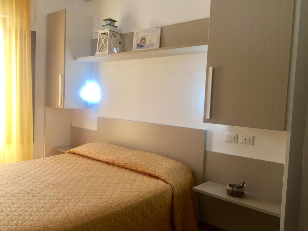 a small bedroom with a bed and a cabinet at B&B San Vito in San Vito lo Capo