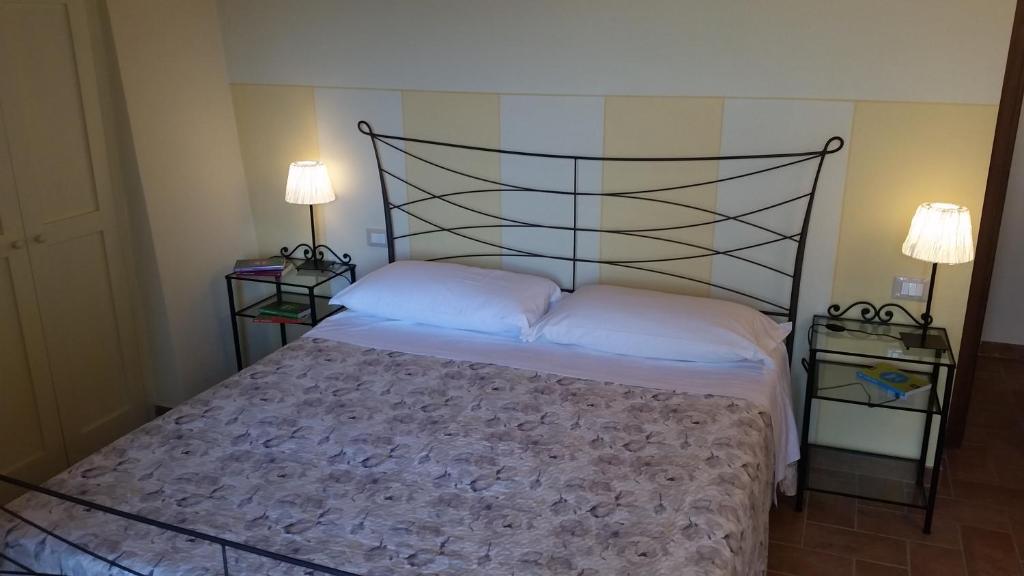 Postel nebo postele na pokoji v ubytování Agriturismo La Quiete