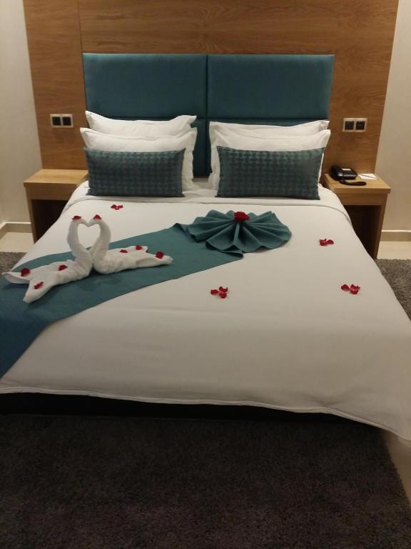 Postel nebo postele na pokoji v ubytování Hôtel Teranga & Spa