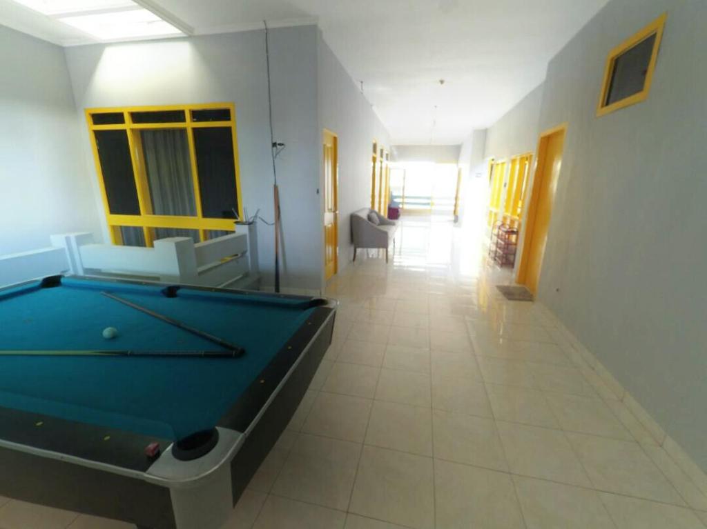 a hallway with a pool table in a room at Mess Inn Semarang in Semarang