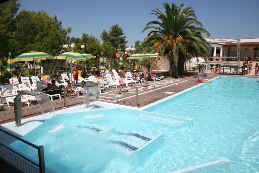 a swimming pool with a fountain in a resort at Villaggio San Pablo in Vieste