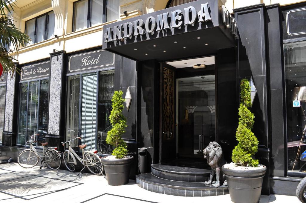 a dog is standing in front of a store at Andromeda Hotel Thessaloniki in Thessaloniki