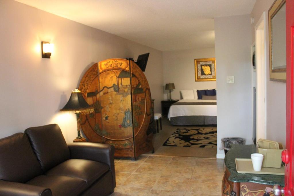 a living room with a room with a bed and a couch at Brydan Suites in Eureka Springs
