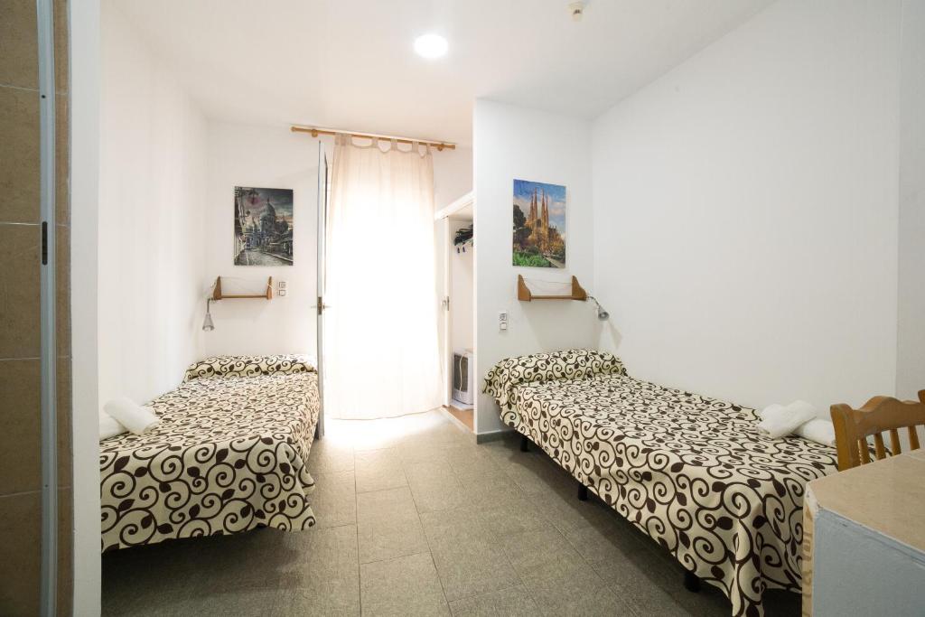 Posteľ alebo postele v izbe v ubytovaní Hospedaje Lisboa Algeciras