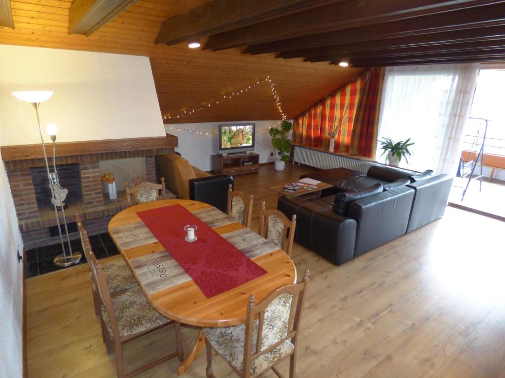 a living room with a table and a couch at Appartment am Waldmattensee in Lahr