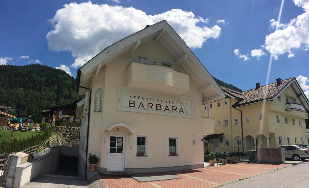 a large white building with a sign on it at EnjoyTheAlps - Appartements BARBARA in Flachau