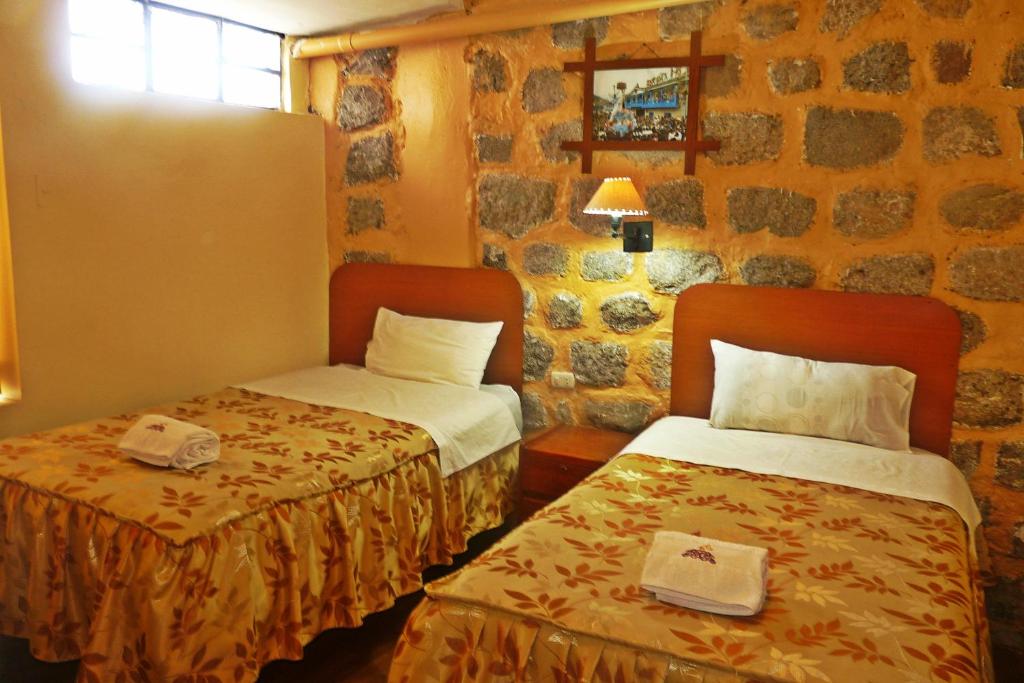 Postel nebo postele na pokoji v ubytování Conquista Cusco
