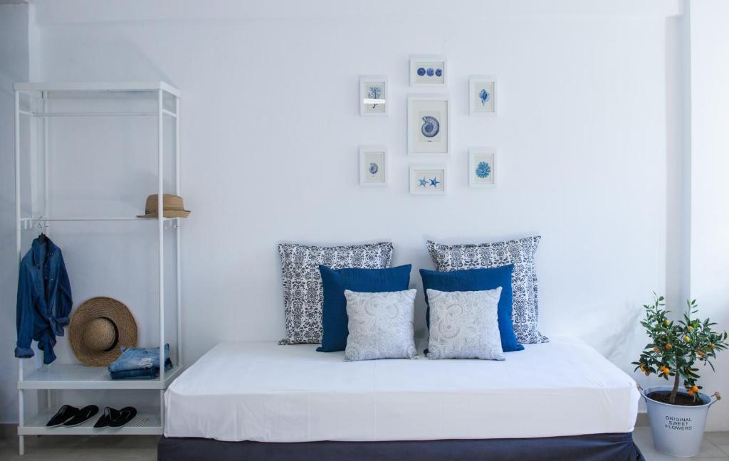 a bedroom with blue and white pillows on a bed at Kohili apartments in Pefkochori