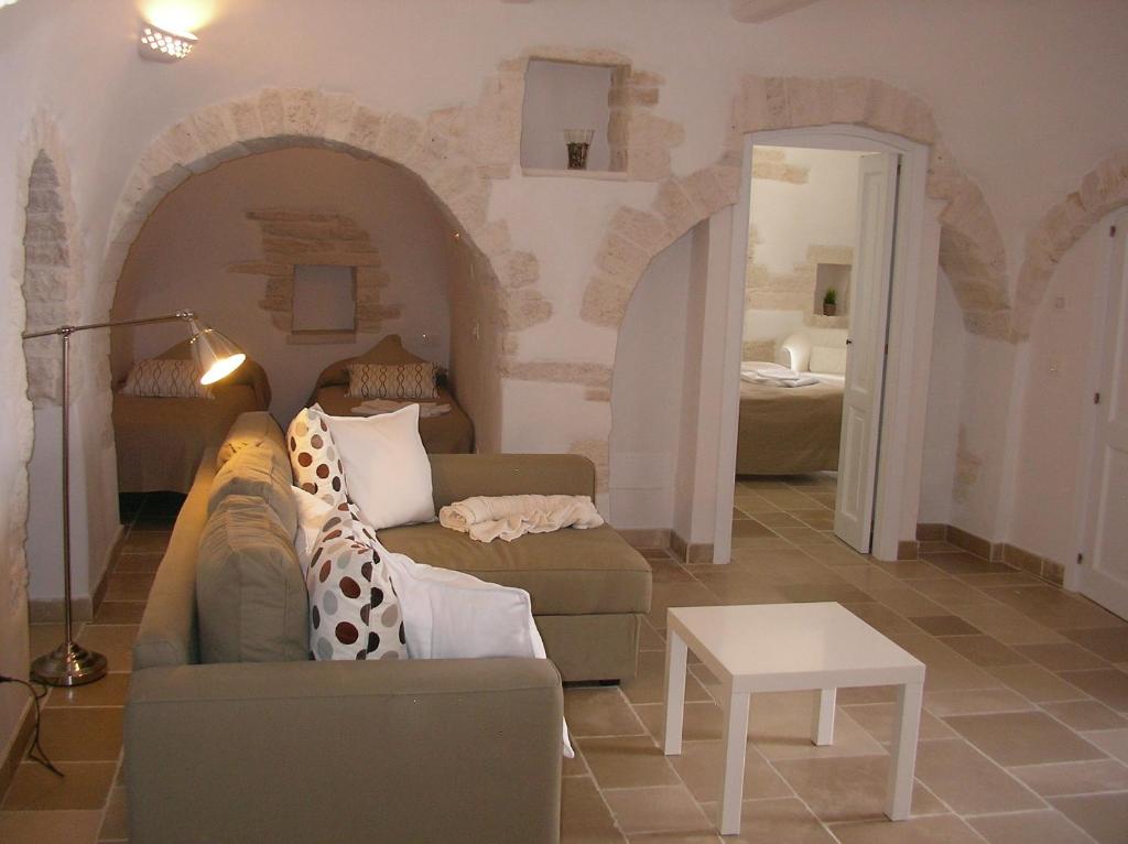 a living room filled with furniture and a large window at Charming Trulli in Alberobello