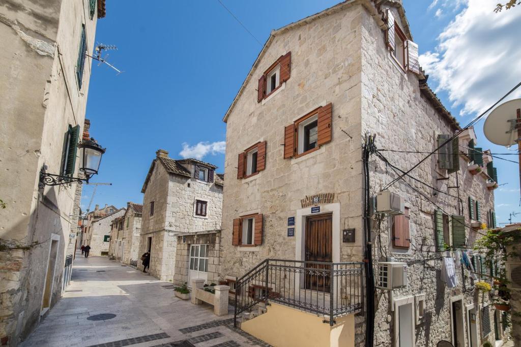 an alley in an old town with stone buildings at Guesthouse Mirula in Split