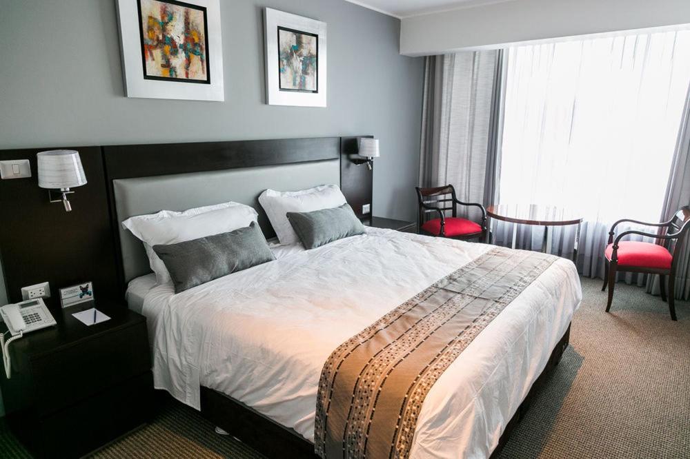 Postel nebo postele na pokoji v ubytování Apart Hotel Petit Palace Suites
