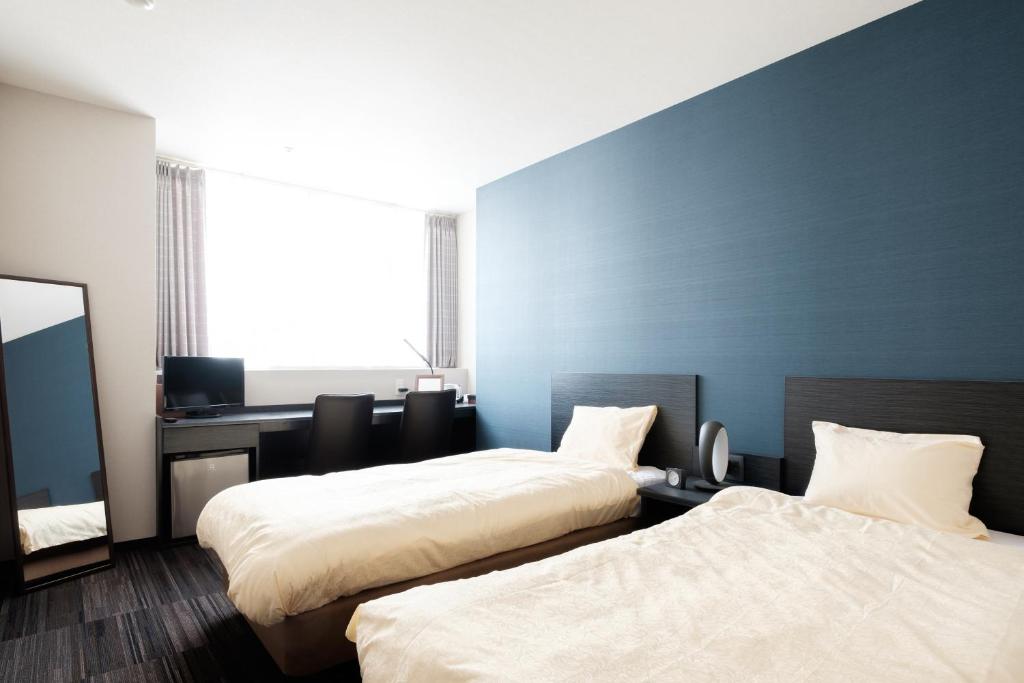Postel nebo postele na pokoji v ubytování The Premium Hotel In Rinku