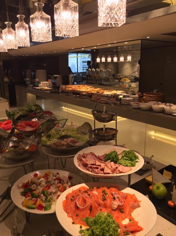 A buffet counter displaying prepared dishes, salads and cold cuts.