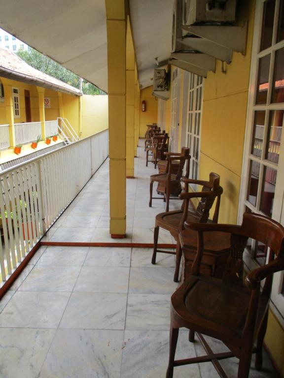 a row of chairs sitting on a balcony at Hotel Tugu Asri in Jakarta