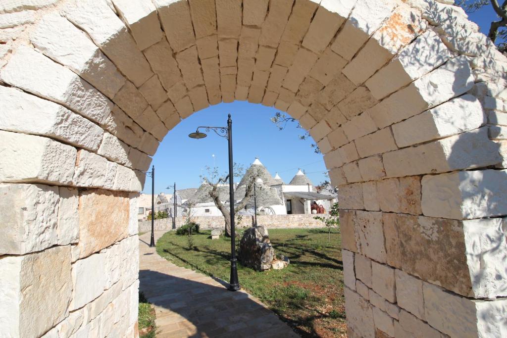 an archway in a stone wall with a street light at Il Gabellota Resort in Alberobello