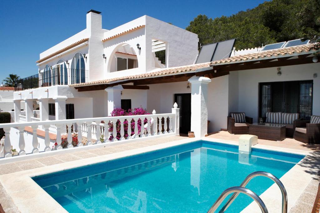 a villa with a swimming pool and a house at Can Carlos Ibiza in Sant Jordi