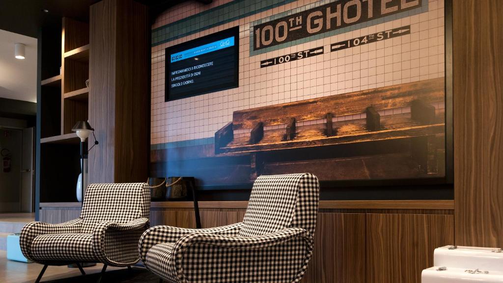 two chairs sitting in front of a large screen at G Hotel Pescara in Pescara