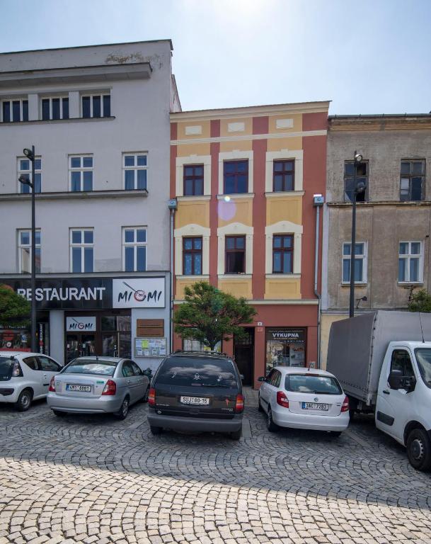grupa samochodów zaparkowanych przed budynkami w obiekcie Apartmán Dolní náměstí w Ołomuńcu