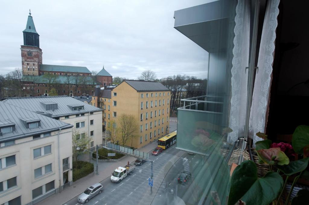 a view from a window of a city street with cars at Cozy Apartment near Turku Cathedral Church in Turku