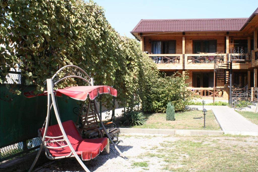 a swing set in front of a house at Guest house Sirius in Pizunda