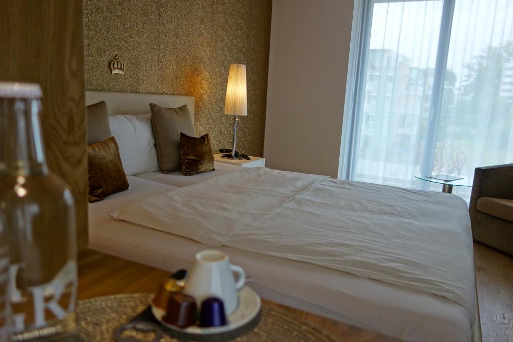 a hotel room with a bed and a window at Hotel AVA in Sempach Station