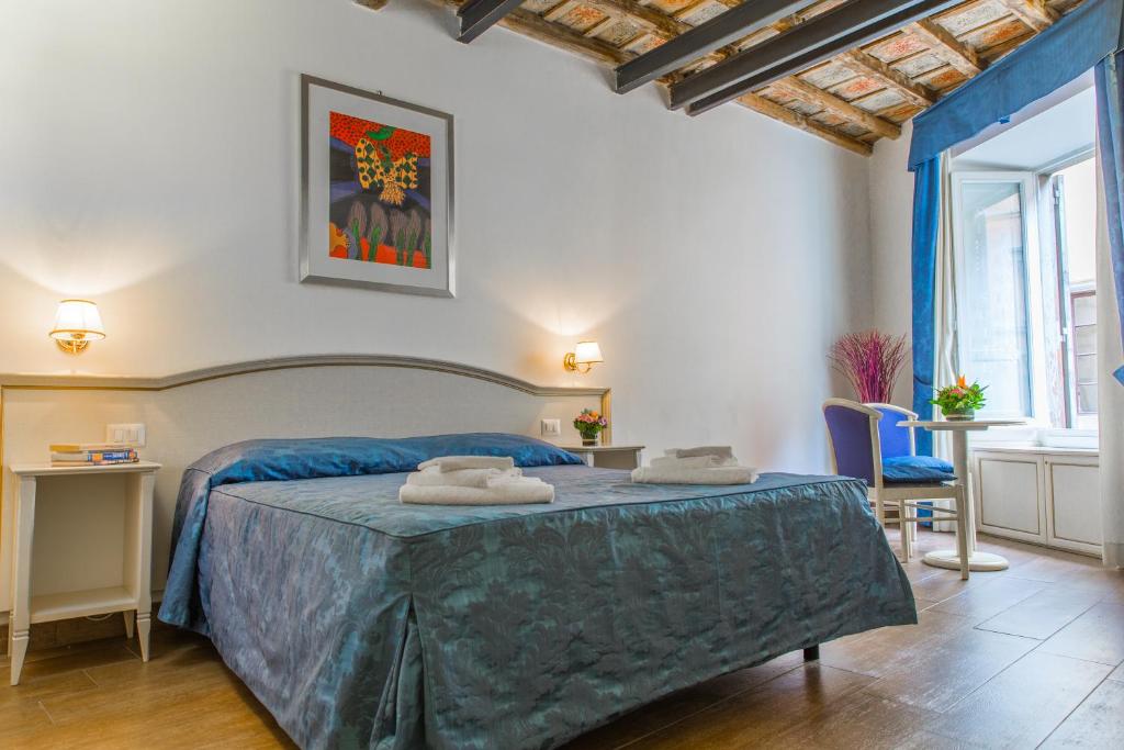 a bedroom with a bed with two towels on it at Best Suites Pantheon in Rome