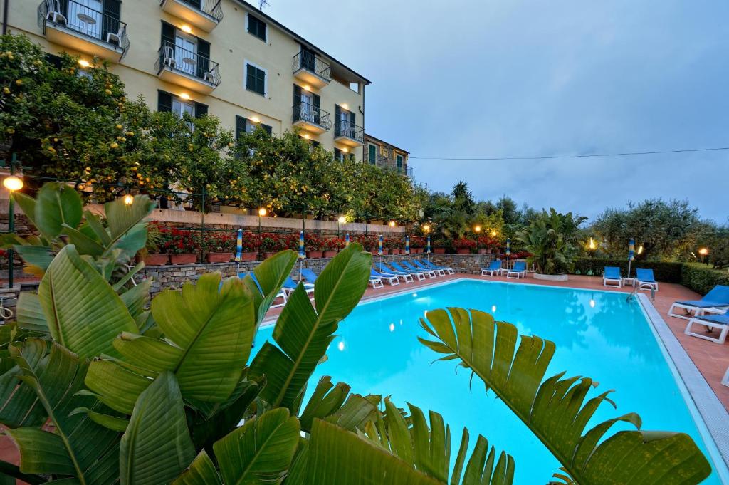 a large swimming pool in front of a building at Residence Elvira in Diano Marina