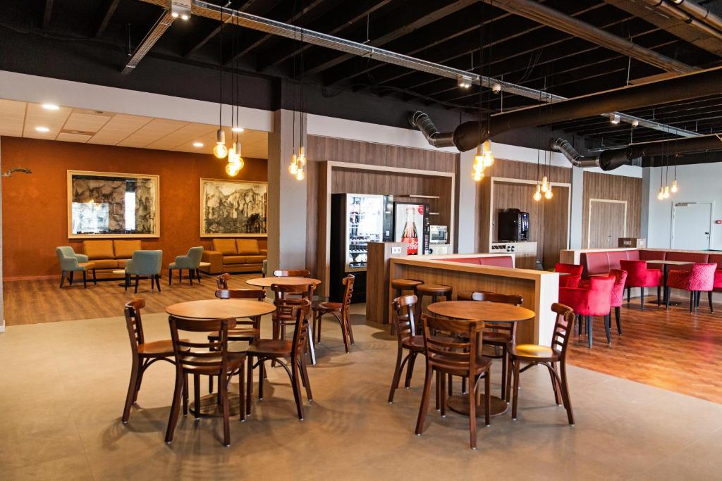 a restaurant with tables and chairs and a bar at Antwerp Harbour Hotel in Antwerp