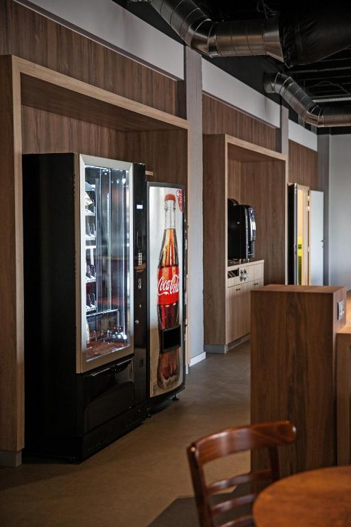 a coca cola refrigerator in a room at Antwerp Harbour Hotel in Antwerp