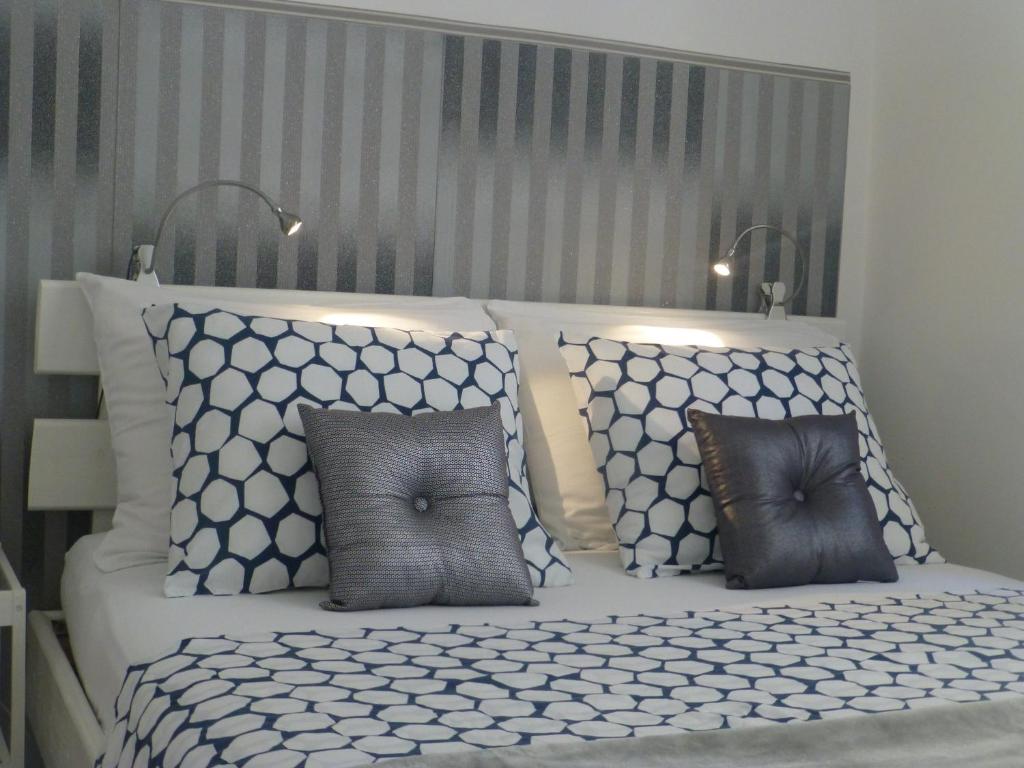 a bedroom with a white bed with pillows at Apartment Emily in Zagreb