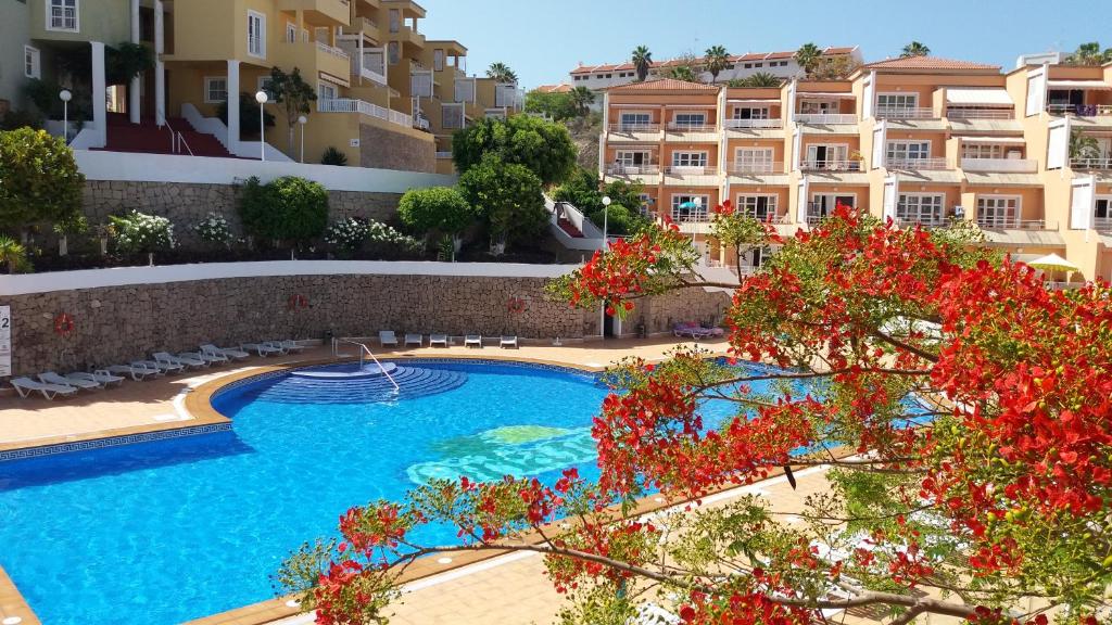 a swimming pool in front of a building at LUX Orlando in Adeje