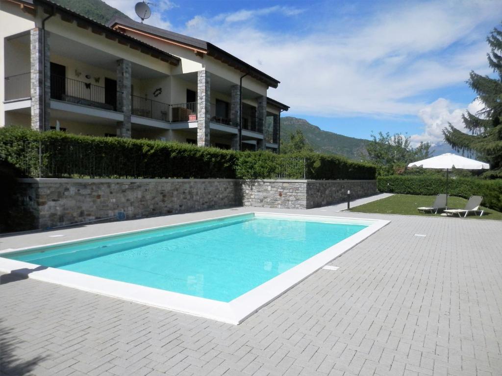 a swimming pool in front of a house at Casa Lella with pool and garden in Lenno