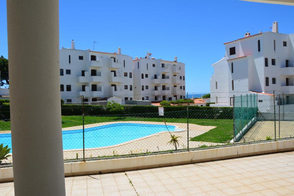 a view of a swimming pool with buildings in the background at Casa Antiquada in Albufeira