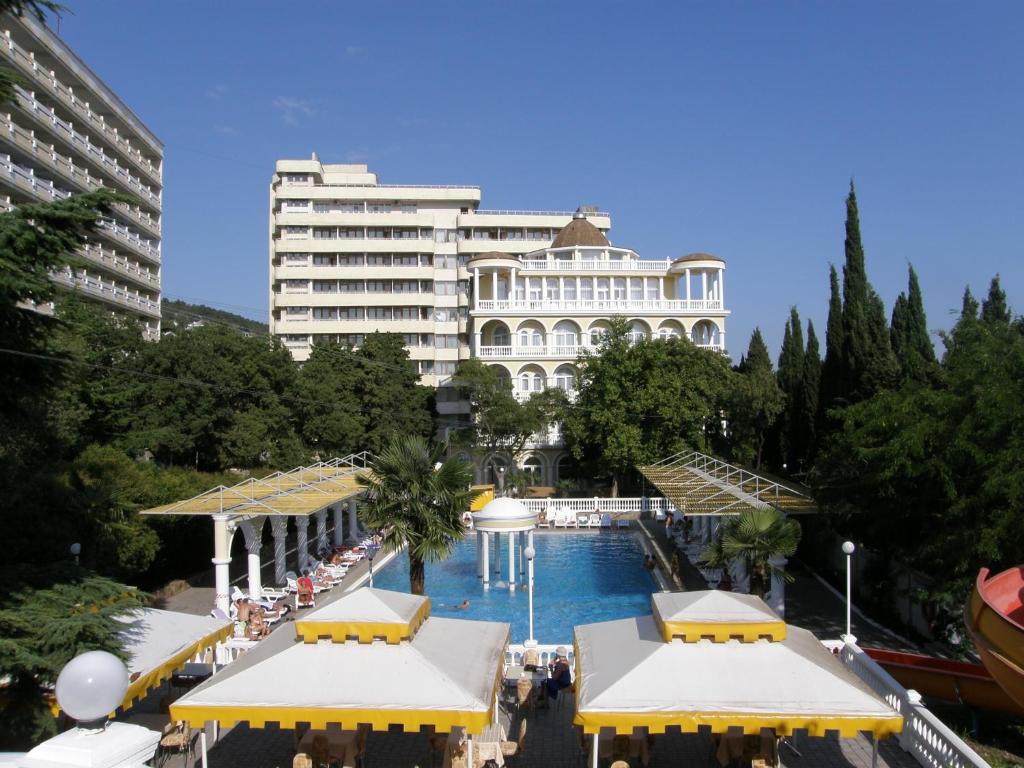 a large hotel with a pool in front of a building at Marat Park Hotel in Gaspra